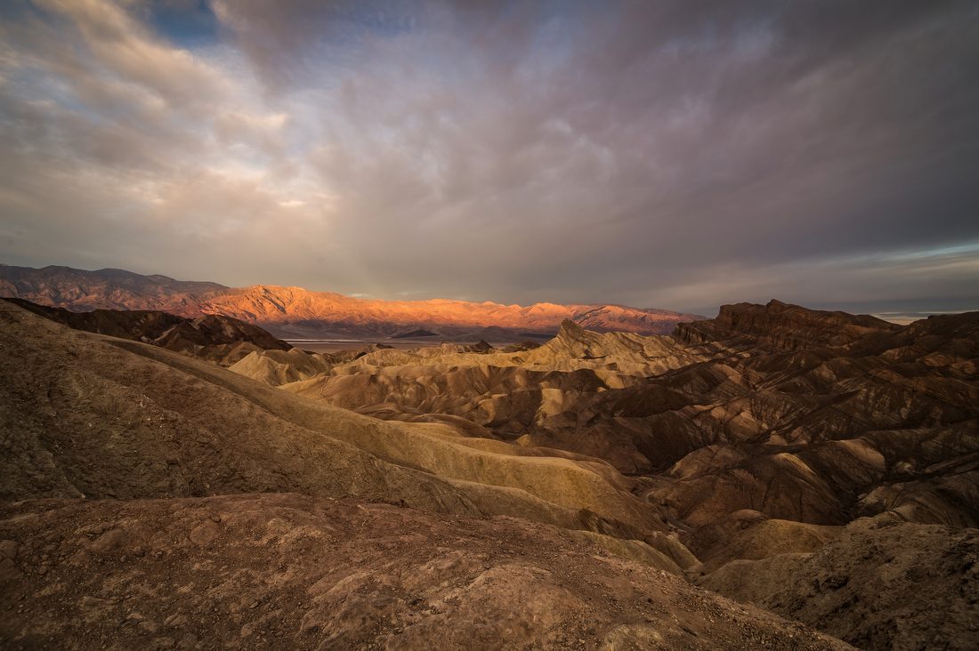 Sunrise light on the golden badlands at Zabriskie Point, Death Valley